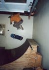 Nick bustin' a huge pop-shuvit on his halfpipe in the garage